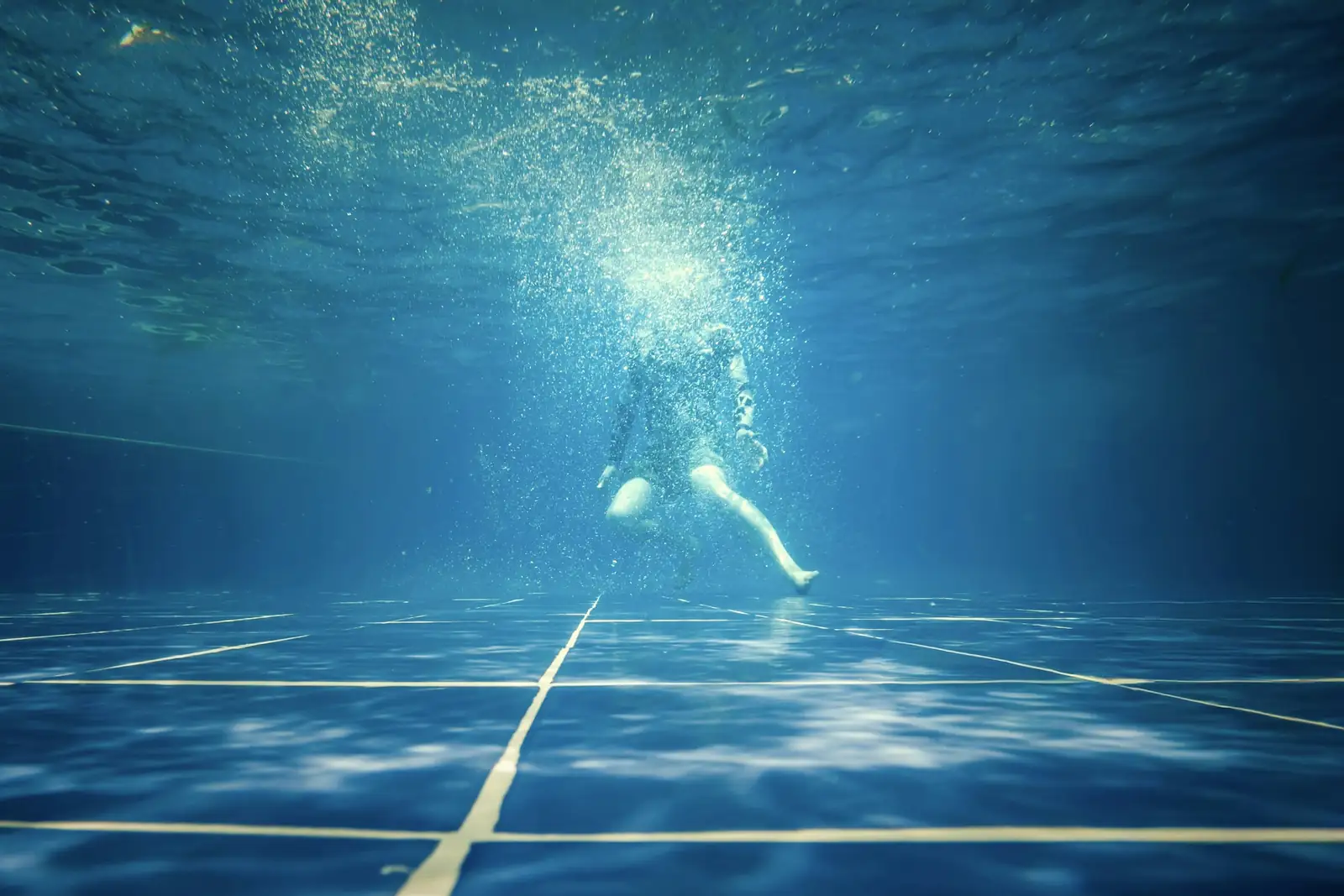 Sunlight streaming down into a blue pool