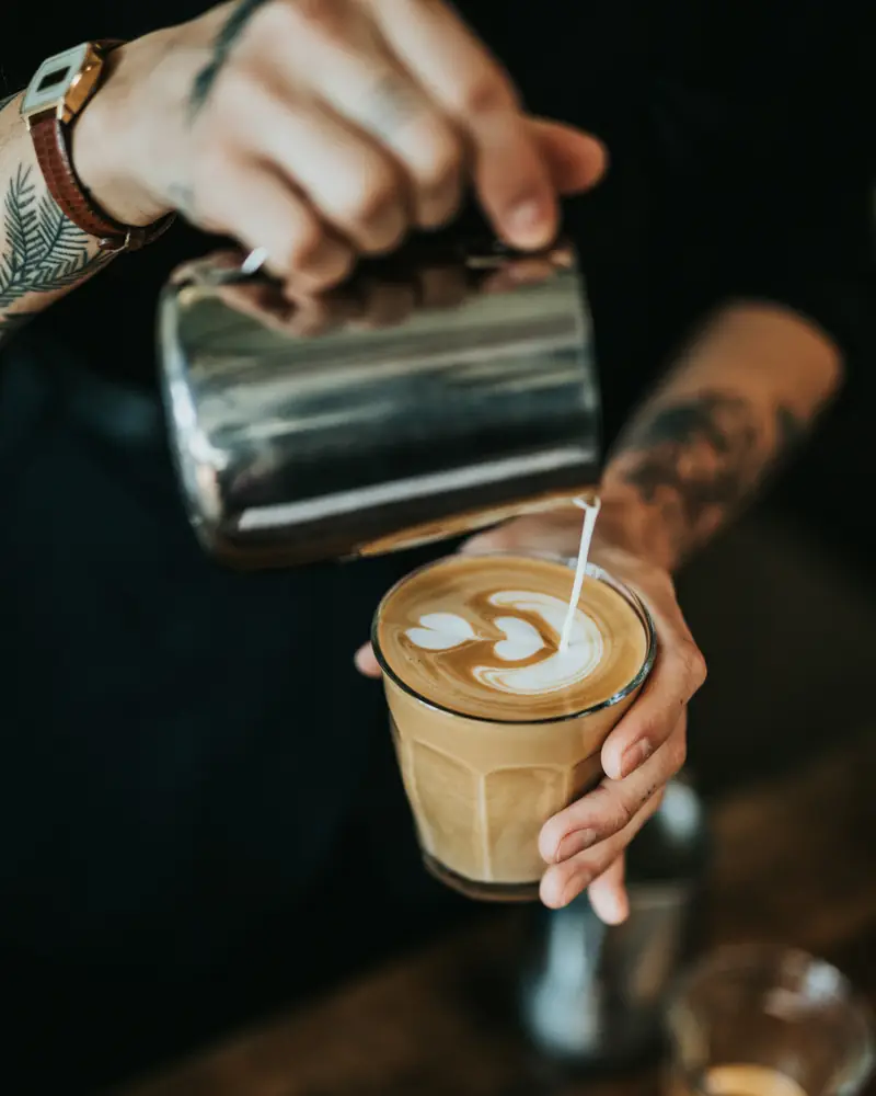 Milk being poured into a latte